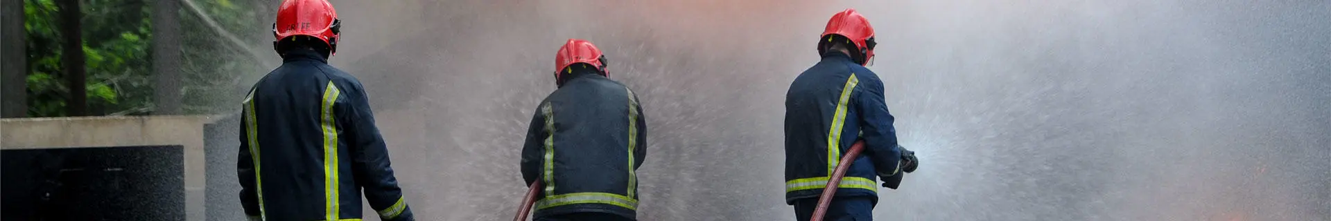 Three fire fighters with a hose