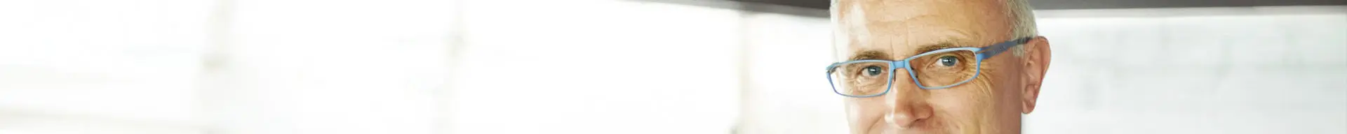 Smiling senior deck officer on the bridge of a ship