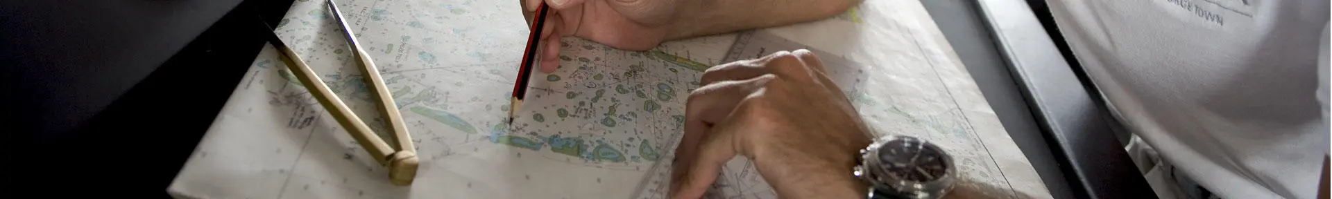Superyacht deck officer plotting a chart