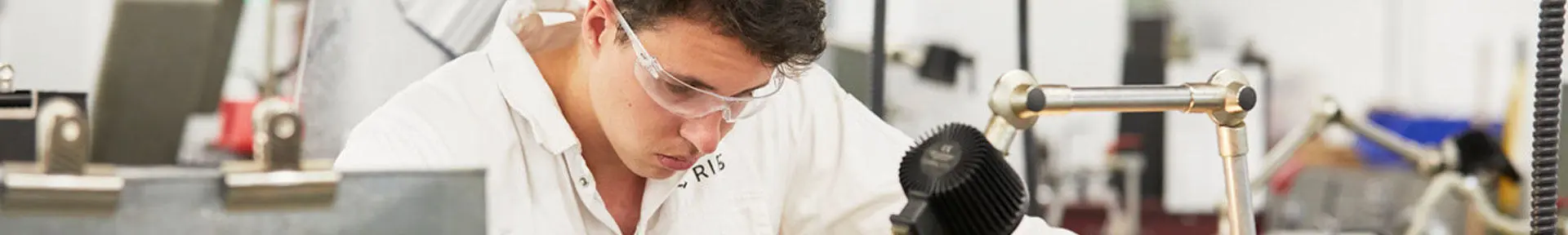 An engineer cadet at one of the workstations in the engineering workshops