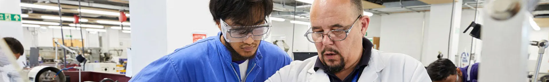 An engineer officer of the watch student with a technician doing workshop skills training in the engineering workshops
