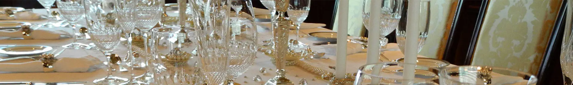 A table laid with crockery and crystal glasses on board a superyacht