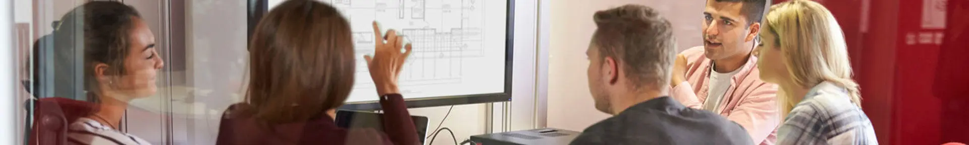 Students and a lecturer looking at some information on a large screen