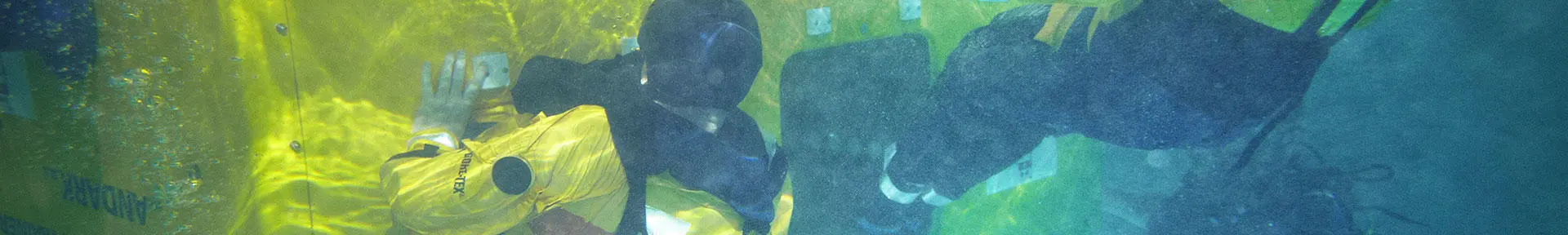 Underwater shot of two students existing the HUET trainer