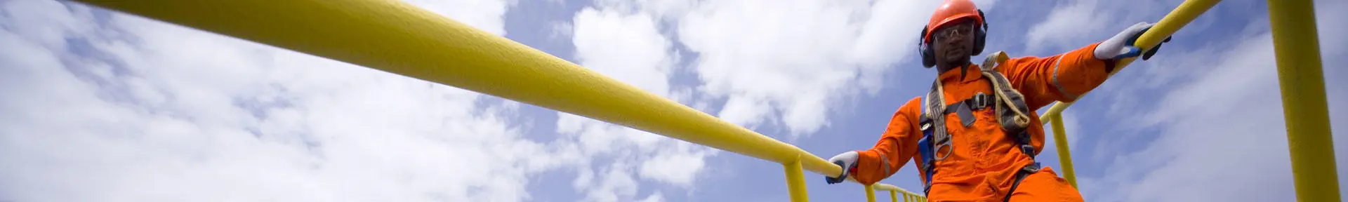 An operative walking down steps on an offshore installation