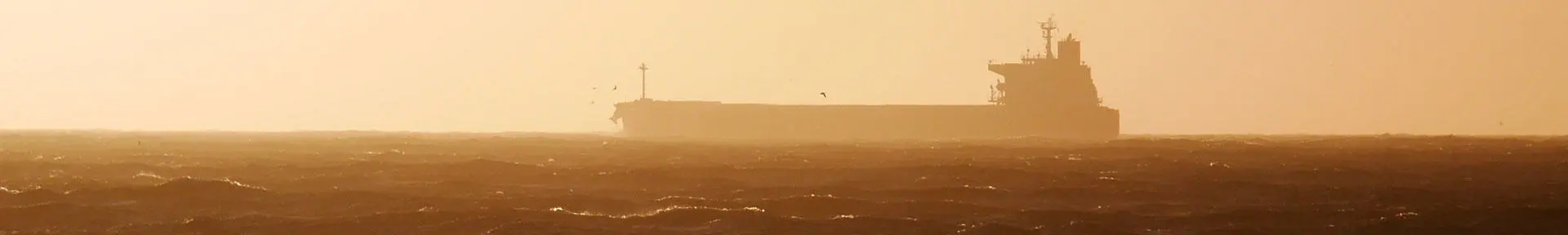 A tanker on the horizon at sunset