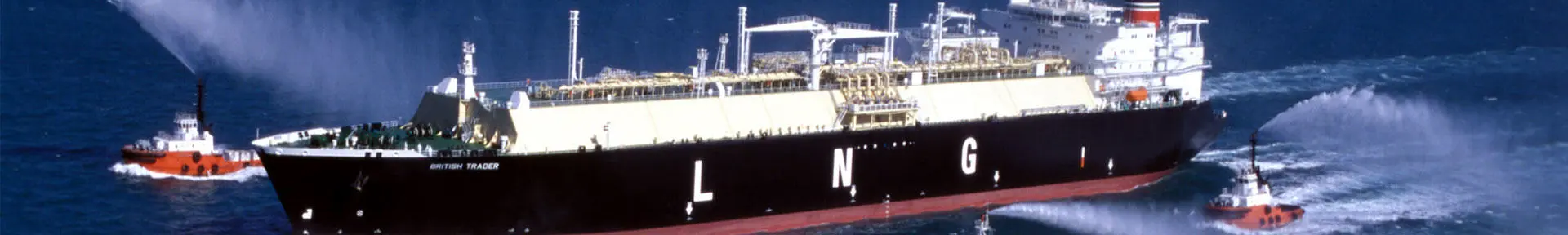 A BP LNG carrier at sea with tugs alongside