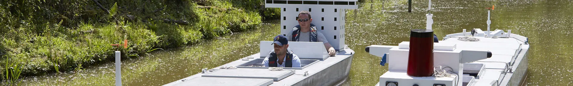 Students doing an exercise in the manned models on the lake