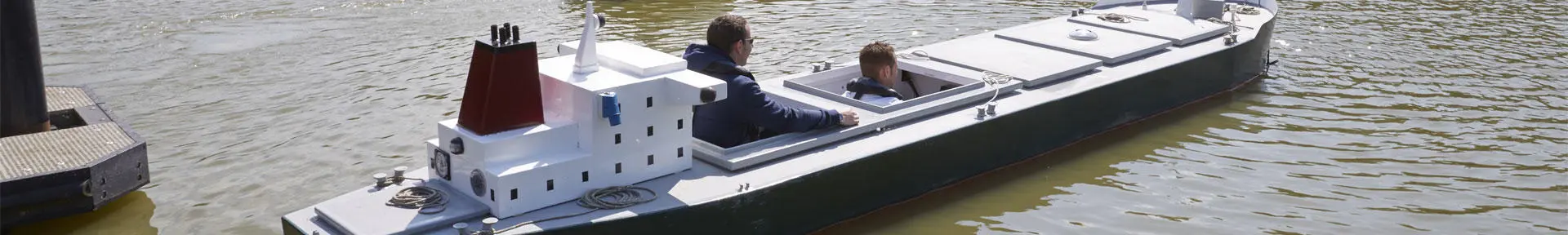 A student doing an exercise in one of the manned models on the lake at the ship handling centre