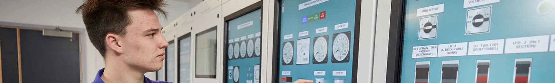 An engineer using the touch screen controls in the engine room simulator