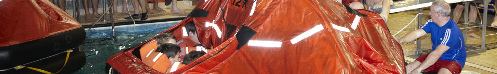 Students in an inflatable life raft during sea survival training in the pool