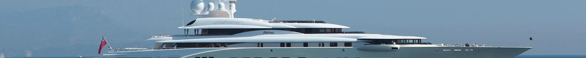 A gleaming white superyacht at anchor