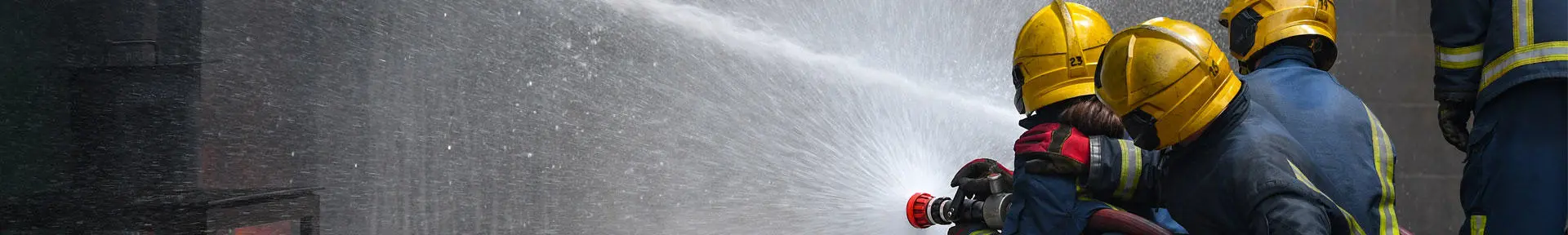 Fire fighting students using a fire hose at the fire ground