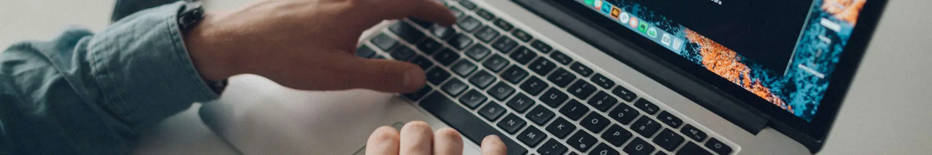 A person typing on a laptop