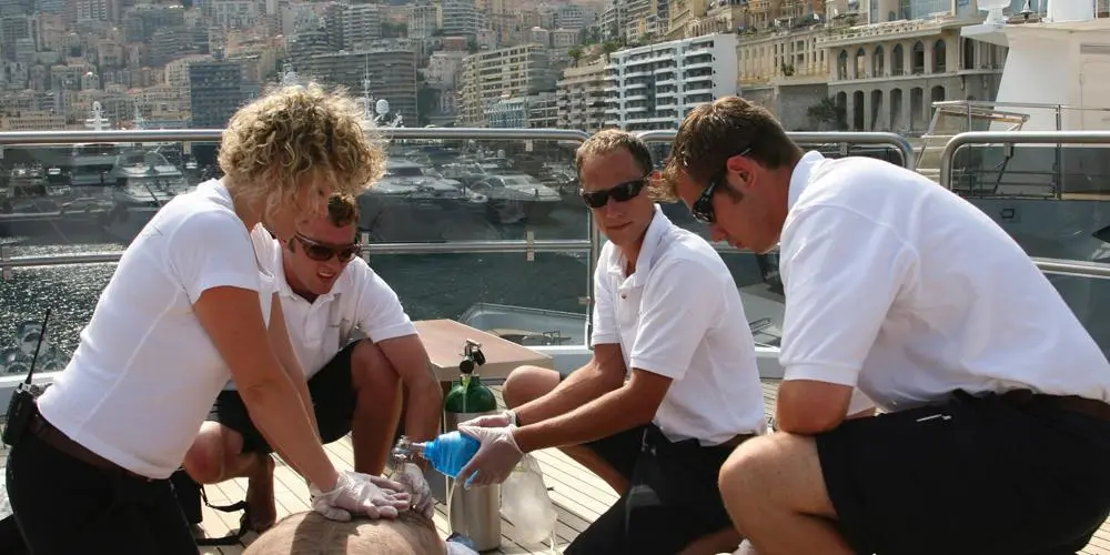 Crew giving medical attention to a casualty on board a yacht