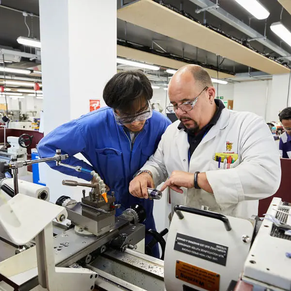 Engineer cadet under instruction from a technician in the engineering workshops