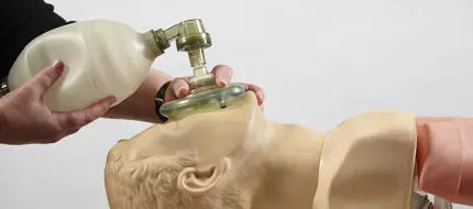 A cadet practicing CPR on a dummy in the medical training centre