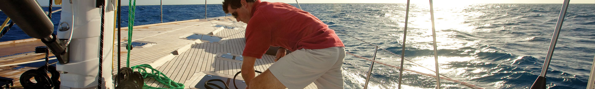 Deck hand tying ropes on a superyacht
