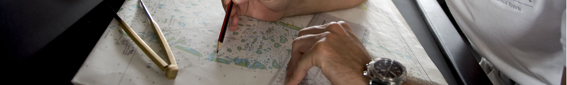 Superyacht deck officer plotting a chart