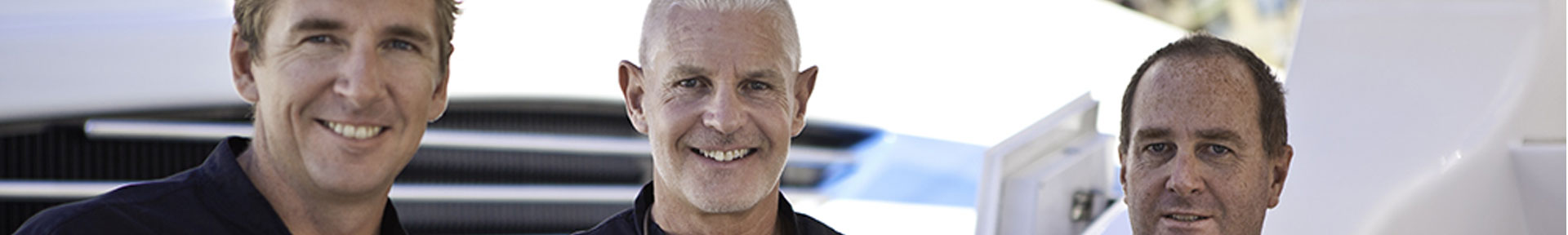 Three yacht officers stood on a superyacht