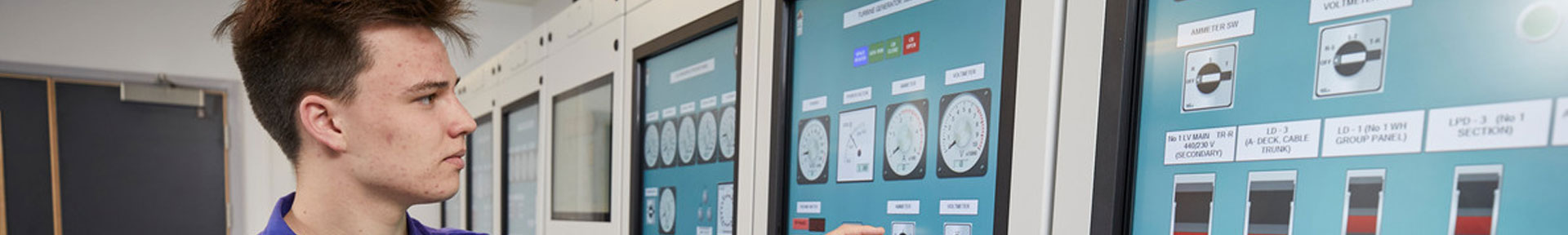 An engineer using the touch screen controls in the engine room simulator