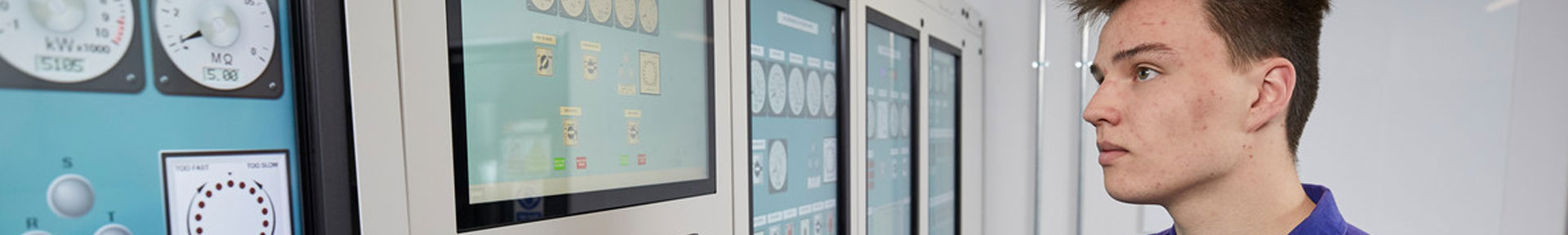 Engineer using the touch screen controls in the engine room simulator