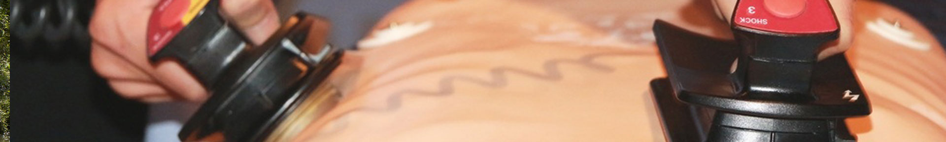 A student practising using a defibrillator on a medical dummy