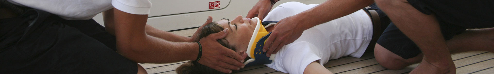 A casualty in a neck brace receiving medical attention