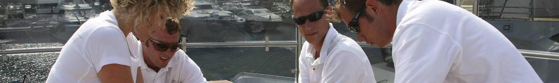 Four superyacht crew members giving medical attention to a casualty