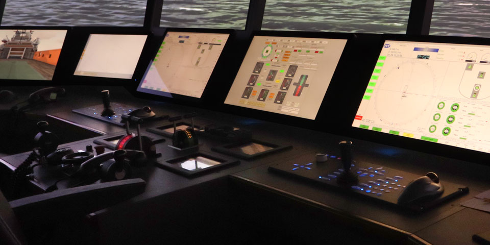 Three deck officers in the bridge simulator