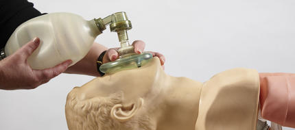 A cadet practicing CPR on a dummy in the medical training centre