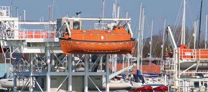 Lifeboat suspended at the end of the pier by the Hamble River