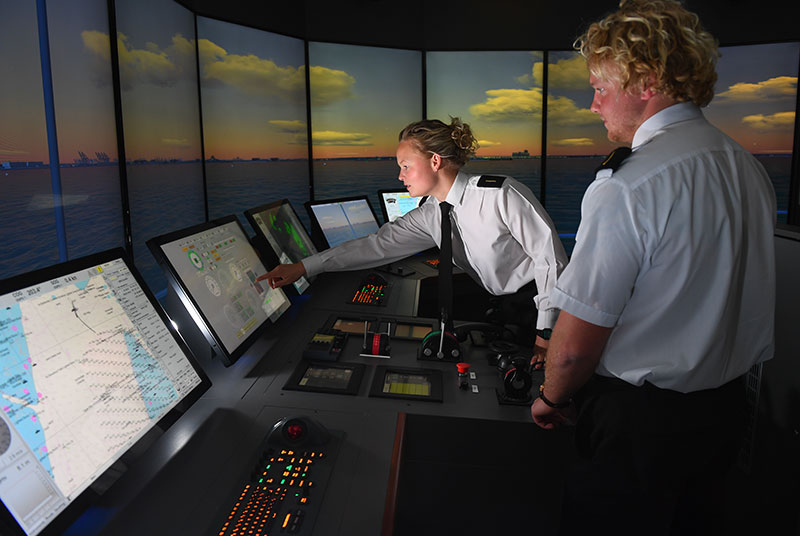 Two deck officer cadets in the bridge simulator